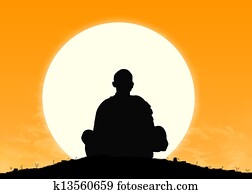 monk in meditation at sunrise