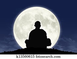 monk in meditation at the full moon