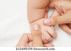 Mother massage and reflexology hand of her baby,touch of Happiness Mother massage and reflexology hand of her baby,touch of Happiness