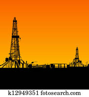 Oil rig silhouettes and orange sky Oil rig silhouettes and orange sky