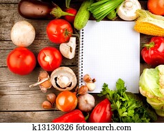 Open Notebook and Fresh Vegetables Background. Diet Open Notebook and Fresh Vegetables Background. Diet