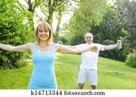 Personal trainer with client exercising outside