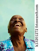 Portrait of funny elderly black woman smiling and laughing