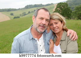 Portrait of happy senior couple in countryside