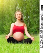 pregnant woman meditating in nature, practice yoga