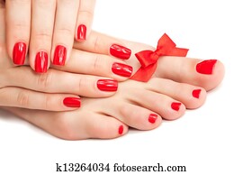 Red manicure and pedicure with a bow Red manicure and pedicure with a bow
