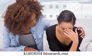 Sad woman crying next to her therapist Sad woman crying next to her therapist