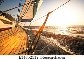 Sailing regatta, during sunset.