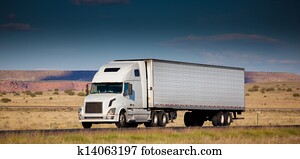 Semi-truck on the road in the desert Semi-truck on the road in the desert