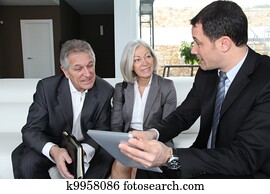 Senior couple discussing financial plan with consultant Senior couple discussing financial plan with consultant