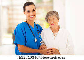 senior woman and caring young nurse
