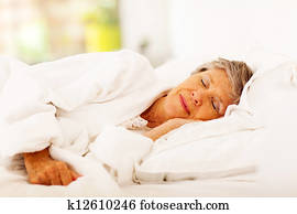 senior woman sleeping on bed