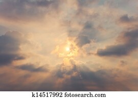 Sky with cumulus clouds and a bright sun