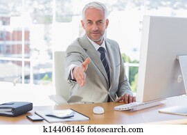 Smiling businessman reaching out hand for handshake
