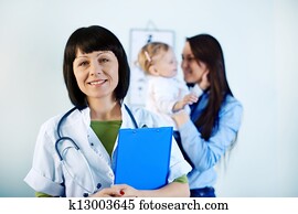 Smiling doctor holding notes