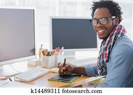 Smiling graphic designer using a graphics tablet Smiling graphic designer using a graphics tablet