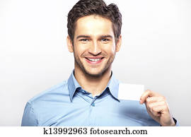 Smiling handsome guy with business card Smiling handsome guy with business card