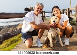 sporty middle aged couple and pet dog