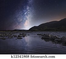 Starry sky over mountain river