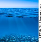 still calm sea water surface with clear sky  and underwater world discovered