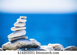 Stones balance, pebbles stack over blue sea in Croatia.