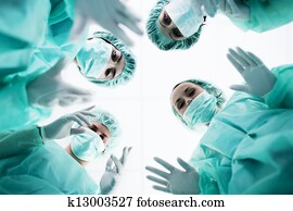Surgeons standing above of the patient before surgery Surgeons standing above of the patient before surgery