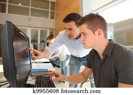 Teacher and student working on computer Teacher and student working on computer
