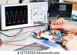 Tech tests electronic equipment in service centre Tech tests electronic equipment in service centre