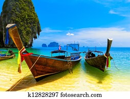 Travel landscape, beach with blue water and sky at summer. Thailand nature beautiful island and traditional wooden boat. Scenery tropical paradise resort Travel landscape, beach with blue water and sky at summer. Thailand nature beautiful island and traditional wooden boat. Scenery tropical paradise resort