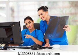 two female healthcare workers working in office