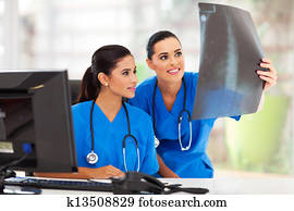 two medical workers studying patient's x ray