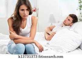 unhappy young couple in bedroom unhappy young couple in bedroom