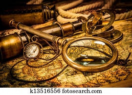 Vintage magnifying glass lies on an ancient world map