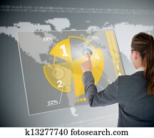 Well dressed business woman using yellow pie chart futuristic interface with map on background