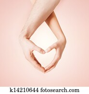 woman and man hands showing heart shape