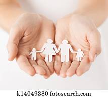 woman's hands with paper man family woman's hands with paper man family