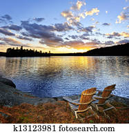 Wooden chairs at sunset on beach