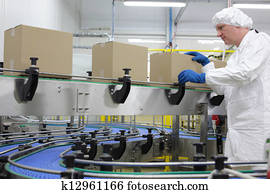 worker at packing line in factory worker at packing line in factory