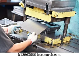 worker operating metal sheet press machine worker operating metal sheet press machine