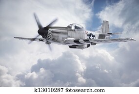 World War II era fighter flies among clouds and blue sky World War II era fighter flies among clouds and blue sky