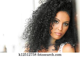 Young black woman, afro hairstyle, in urban background