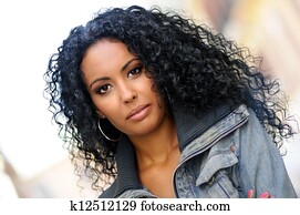 Young black woman, afro hairstyle, in urban background