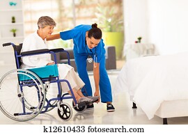 young caregiver helping elderly woman young caregiver helping elderly woman