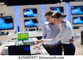 Young couple in consumer electronics store