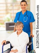 young nurse pushing senior woman young nurse pushing senior woman