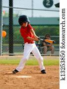 Youth baseball player swinging bat
