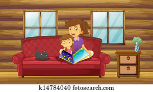 A mother reading with her daughter at the sofa A mother reading with her daughter at the sofa