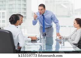 Angry executive pointing out his employee