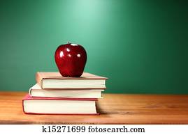 Apple Plus Stack of Books on A Desk for Back to School Apple Plus Stack of Books on A Desk for Back to School