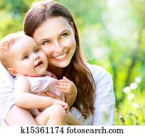 Beautiful Mother And Baby outdoors. Nature 